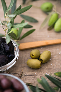 green olives of wooden table background.
