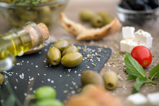 antioxidant healthy green olives in black plate.