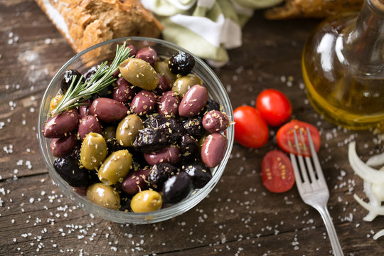 Mediterranean mix of olives for salad in oil top view.