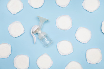 Manual breast pump with breast pads on the blue background © triocean