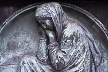 Tombstone relief of a grieving mother on a cemetey in Muenster-Germany  