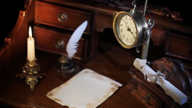 Candle, hours, the papyrus on an ancient table of 19 centuries