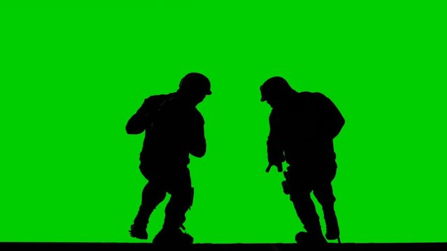 Two Silhouettes of  Special Ops Soldiers Jump with Ropes from The Buildung with Chroma key Mock-up Green Screen Backrgound. SWAT Action Operation.