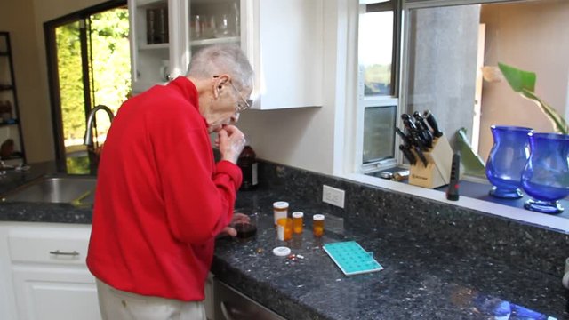 Elderly man taking medication with prune juice