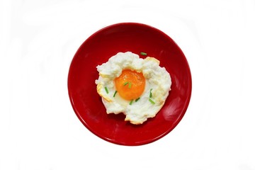 Baked Cloud egg on red plate isolated on white, directly above