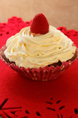 Homemade delicious chocolate cupcakes with fresh raspberry and cream on top. Delicious cupcake for Valentine’s Day. 
