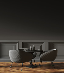 Black round table in a black wall cafe corner