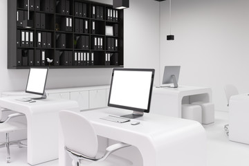 Two computers with blank screens, office side
