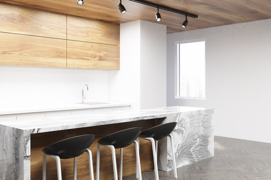 White and wooden kitchen corner with a bar