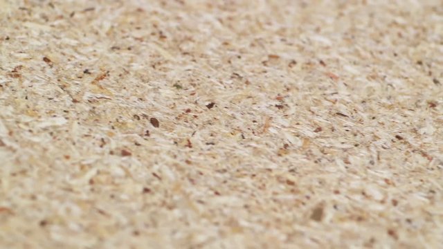 Chipboard texture close-up. Smooth rotation. Quality control in furniture production. Paperboard.
