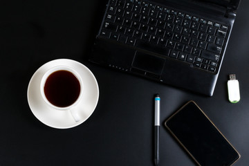 laptop phone cup of tea and biscuits with a bitcoin sign on the table