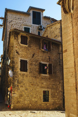 Fototapeta na wymiar Narrow streets of the ancient city-fortress of the Mediterranean. Travel to Montenegro, Kotor.