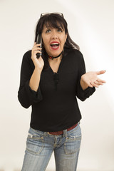 brunette woman talking on cell on white background with kind and happy attitude