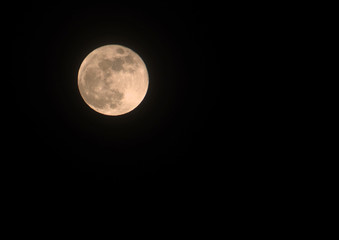 orange full moon at supermoon 31 january 2018 in a black sky