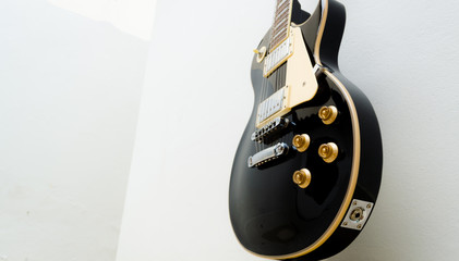 black guitar model les paul on a white background showing part of the body in a bottom view - obrazy, fototapety, plakaty