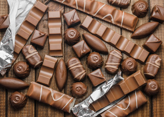 Background of chocolates, bars and sweets, free space for text, close up