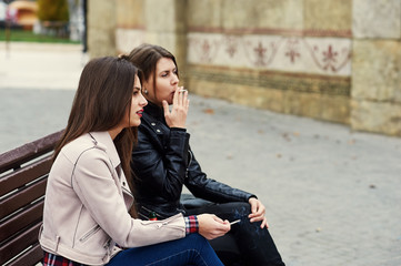 girls smoke in the city .Bad habits of people