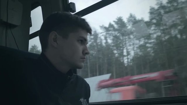 Sad caucasian young man see to car window. Filmlook HD video.