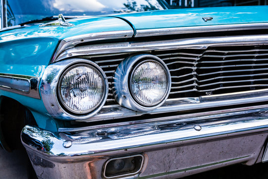 Blue Ford Galaxy 500 close up of grill and headlights