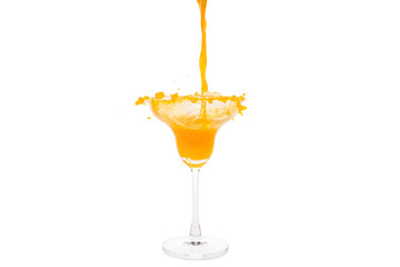 orange juice pouring in glass isolated on white background