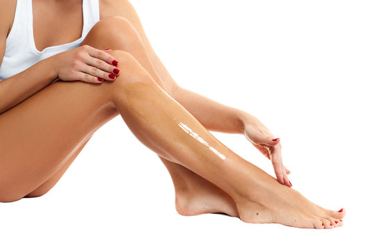 Depilation and Waxing. Woman putting depilatory wax on her leg