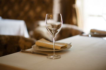 Beautiful table setting, with glasses and utensils.