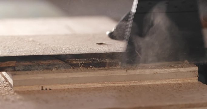 Master cuts wood with a jig saw