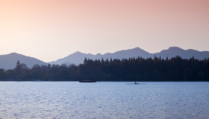 Coastal landscape with rower on West Lake