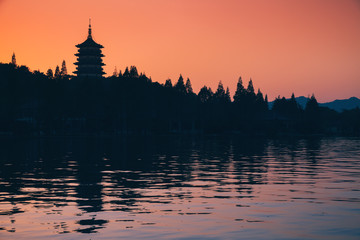 Fototapeta na wymiar Silhouette of pagoda over bright evening sky