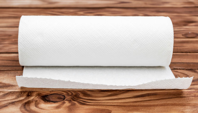 Paper kitchen towel on the wooden table.
