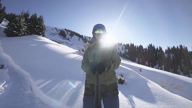 Snowboarder man making selfie use action camera gopro