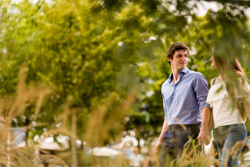 Candid shot of a romantic couple walking in park