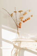 Clear Glass Vase with Dried Blooms on Fireplace Mantel