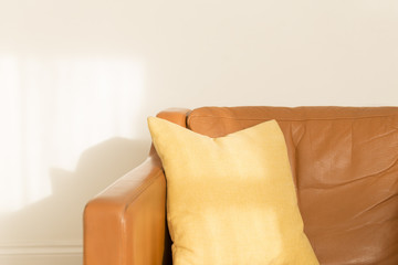 Square Pillow on Leatherette Armchair over White Background
