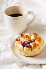coffee cup and bread in bed, cozy breakfast