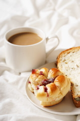 coffee cup and bread in bed, cozy breakfast