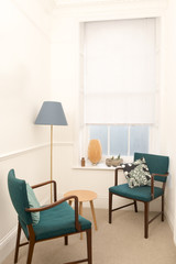 Vintage Wooden Armchairs with Green Cushion by a Window