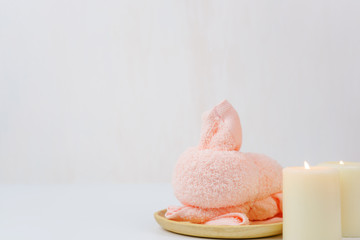 spa wellness set.beauty and fashion set on the white table.spa towel with candle and plumeria, tree on the white table.