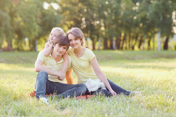 Fototapeta premium Happy family in the park on a sunny day in the summer.