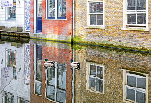 Reflection at water canal in city Delft, Netherlands
