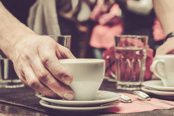 Waiter serving a cup of coffee on a table