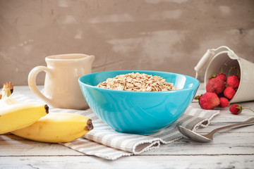 Oat flakes in a bowl with fruits ready to cook