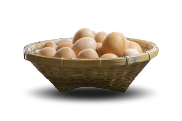 Group of eggs in a bamboo basket isolated on white background, with clipping path.