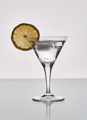 martini glass with cocktail and lemon slice