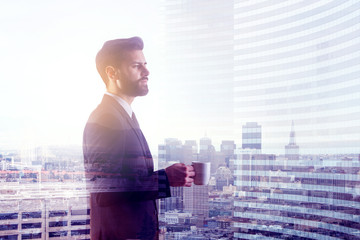 Man drinking coffee in city