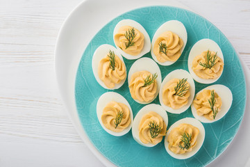 stuffed eggs on blue plate for easter table