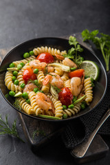 pasta salad with avocado, shrimps, tomato  and grean peas