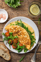 omelette with spinach, green peas and arugula for breakfast