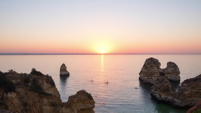 Amazing timelapse of sun rising over Atlantic ocean, view from the Playa de Camilo beach, Portugal.