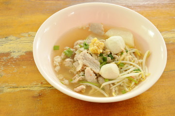 boiled slice pork and ball with bean sprout in clear soup on bowl